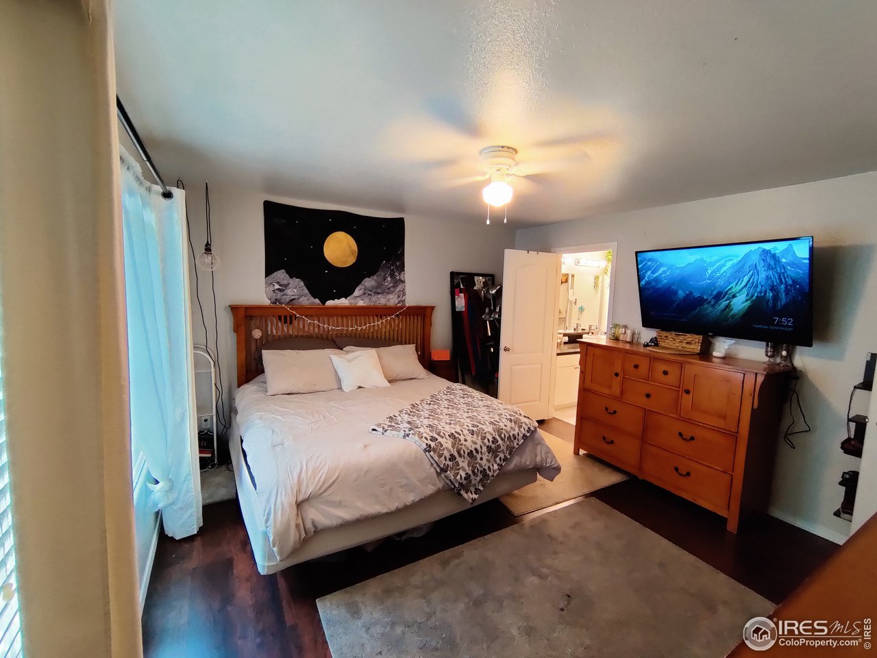 10567 Titan Avenue Firestone, CO 80504 - Photo 11 of 17 a bedroom with a bed and wooden floor