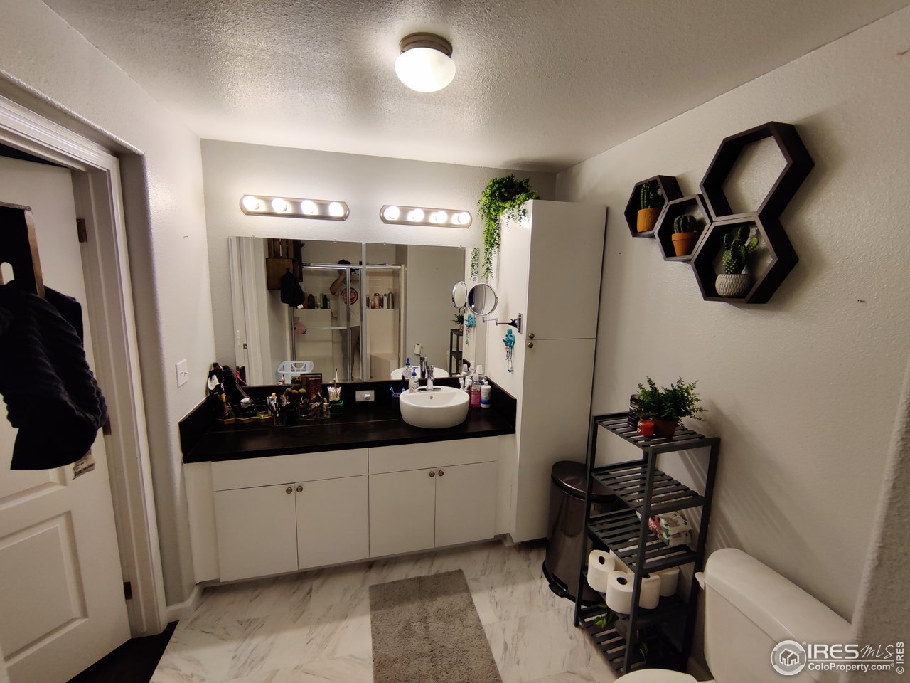10567 Titan Avenue Firestone, CO 80504 - Photo 14 of 17 a bathroom with a sink and mirror