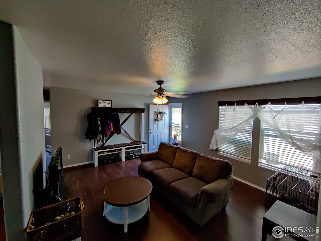 10567 Titan Avenue Firestone, CO 80504 - Photo 3 of 17 a living room with furniture a desk and a chandelier