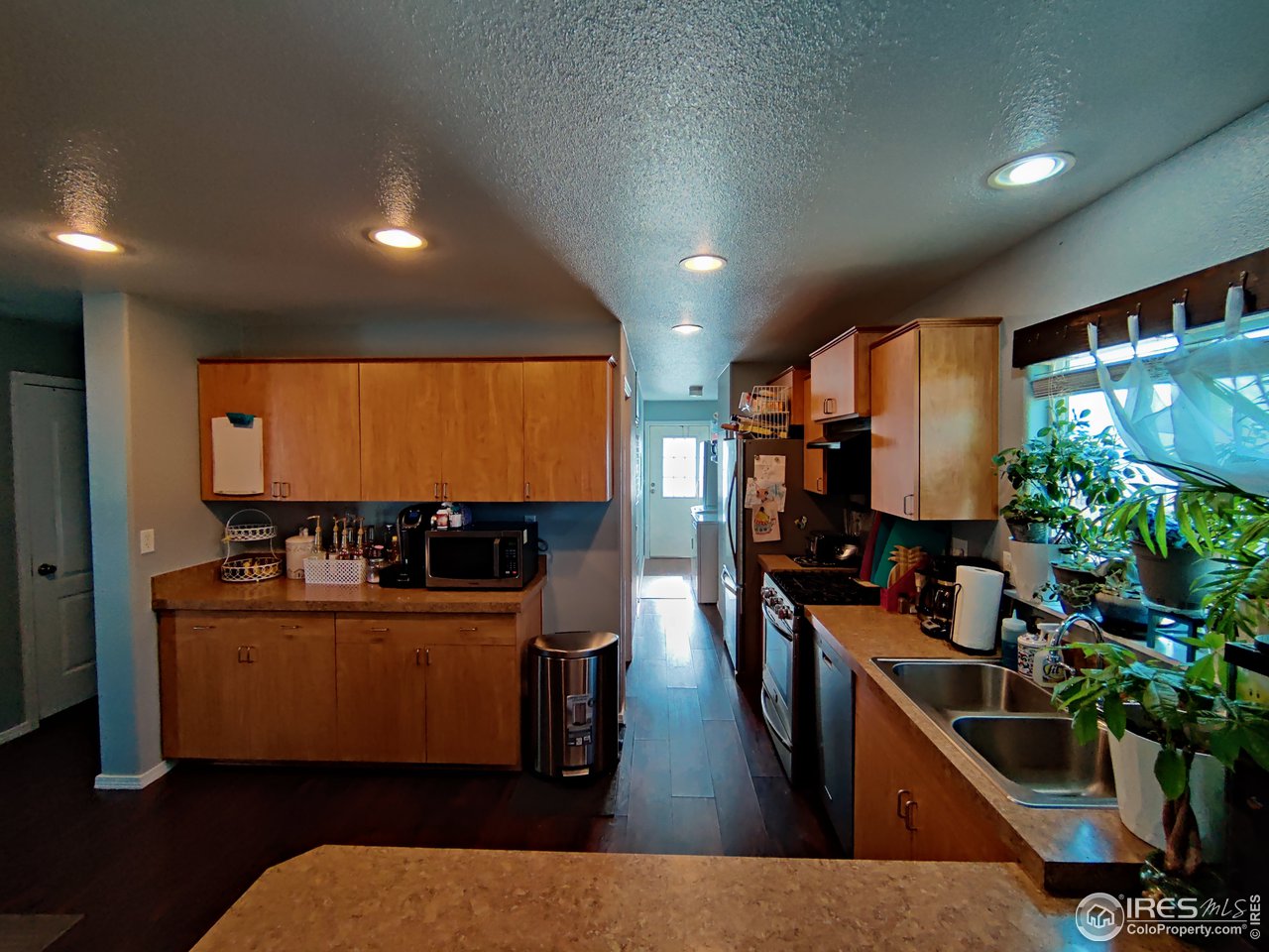 10567 Titan Avenue Firestone, CO 80504 - Photo 5 of 17 a living room with furniture a flat screen tv and a large window