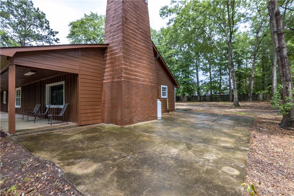 25 Gas Line Road Phenix City, AL 36870 - Photo 46 of 52 View of property exterior featuring a chimney and a patio