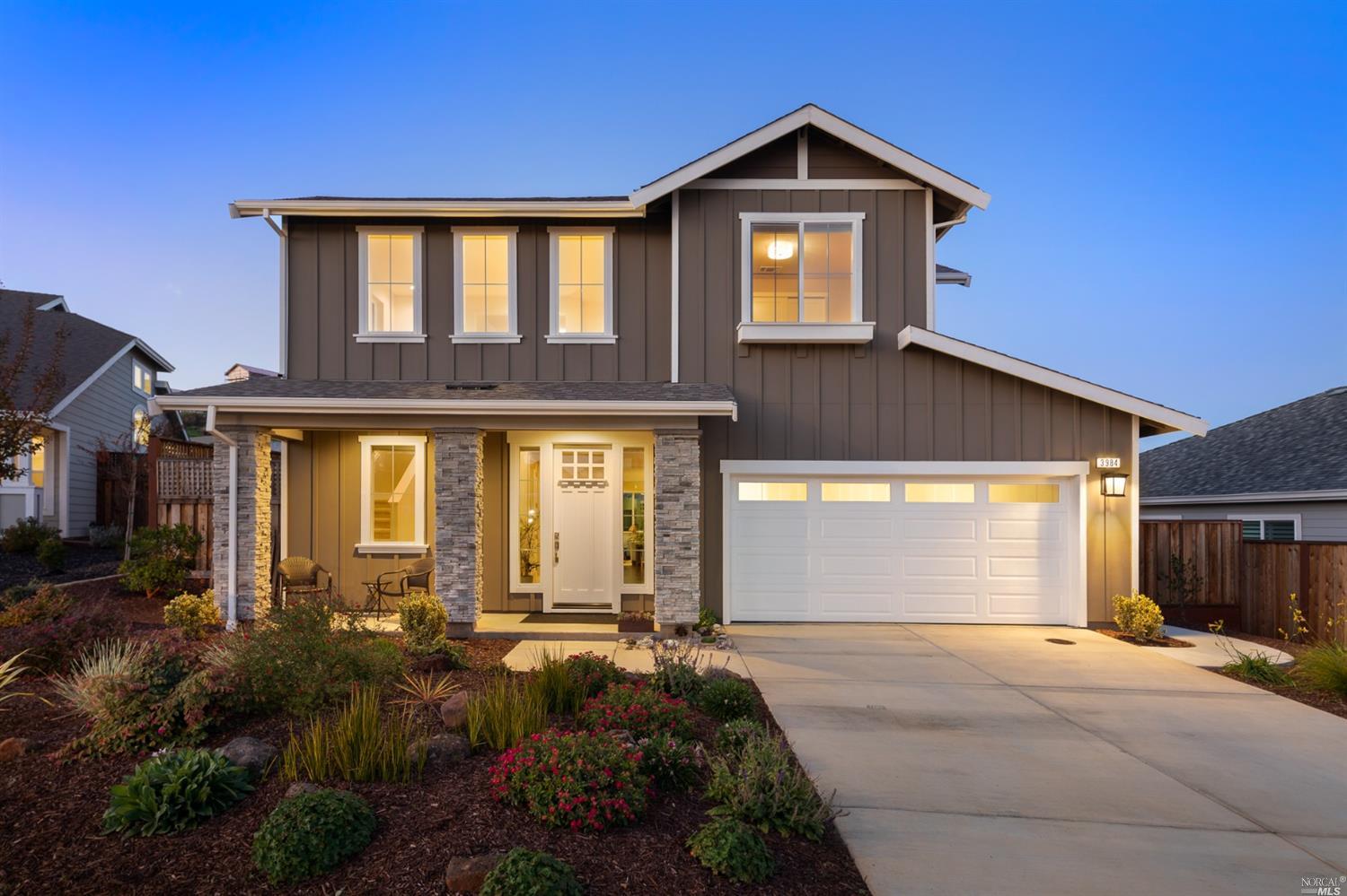 3984 Millbrook Drive Santa Rosa, CA 95404 - Photo 1 of 1 a front view of a house with a yard and garage