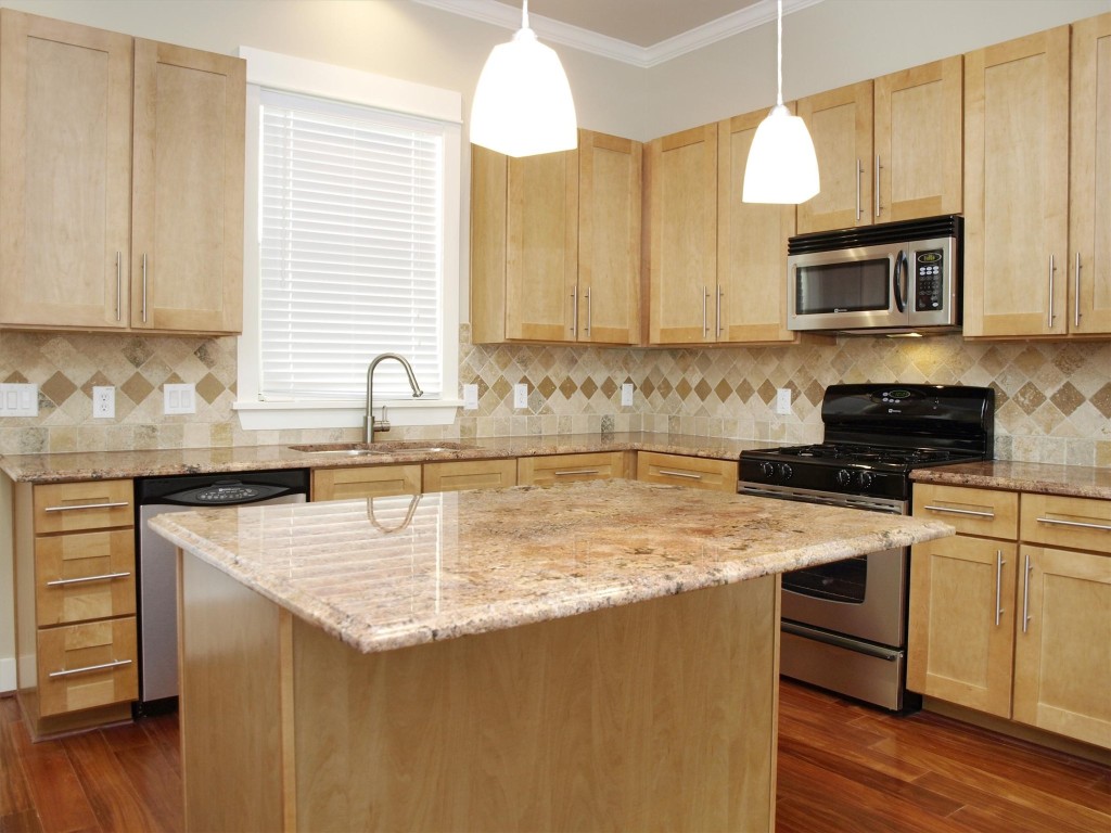 4514 Depew Avenue, Unit A Austin, TX 78751 - Photo 4 of 7 a kitchen with stainless steel appliances granite countertop a sink a stove and cabinets