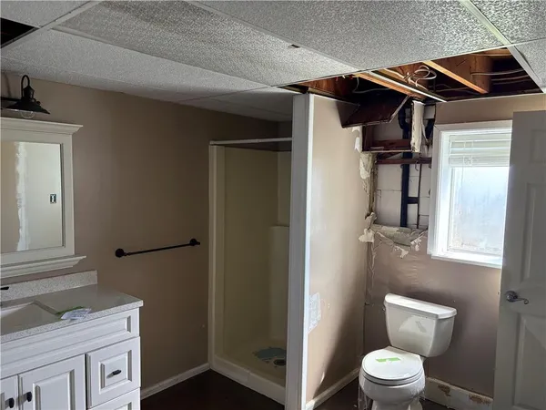 a bathroom with a toilet sink and shower