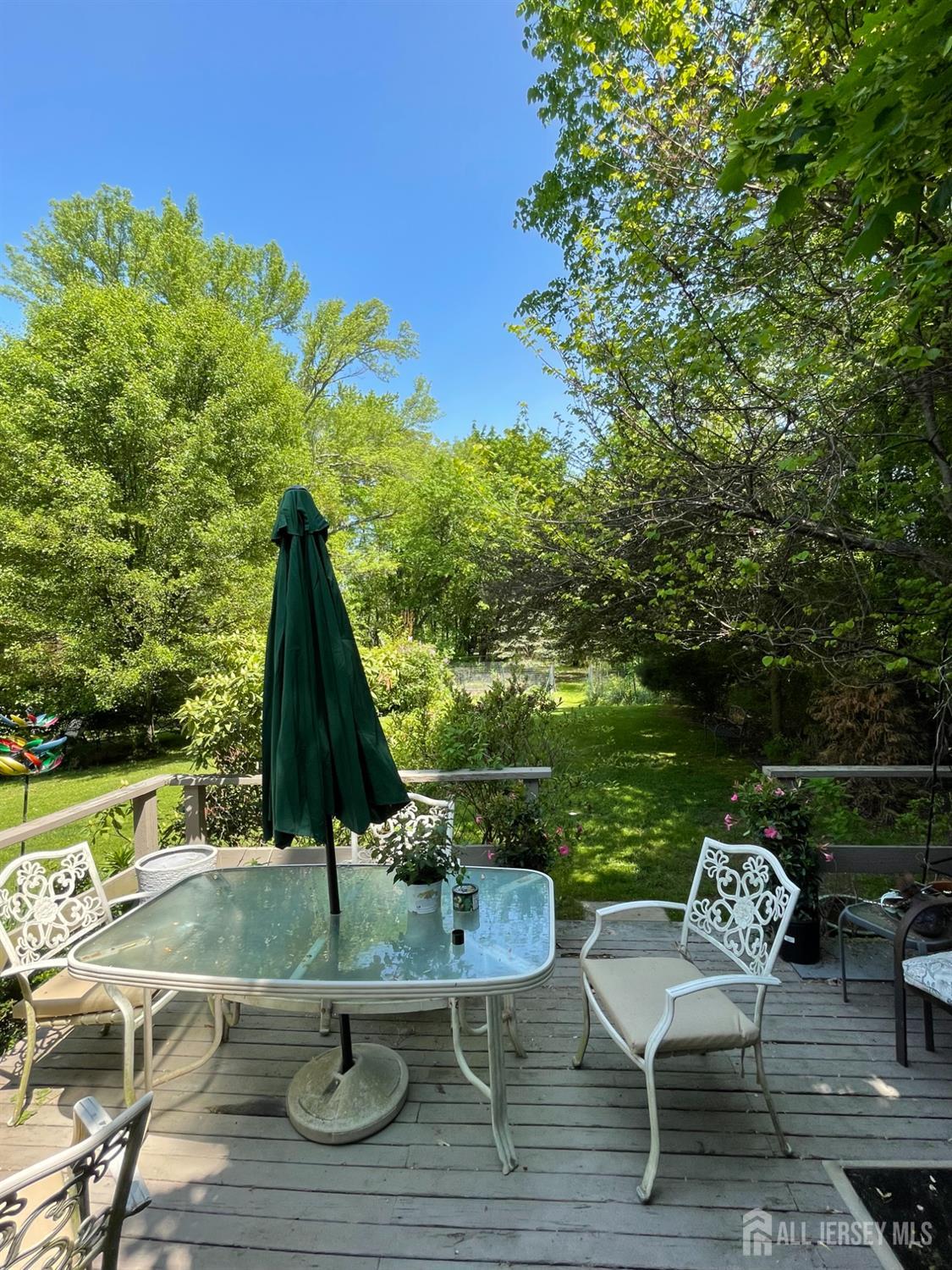 181 Disbrow Hill Road Monroe Township, NJ 08831 - Photo 12 of 21 a view of a lake with couches and wooden floor