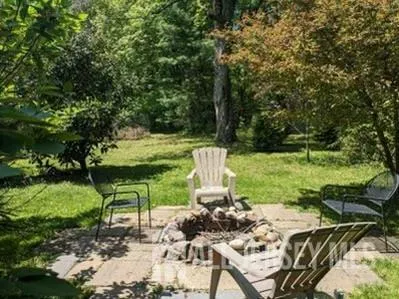 a view of a chairs and table in the garden