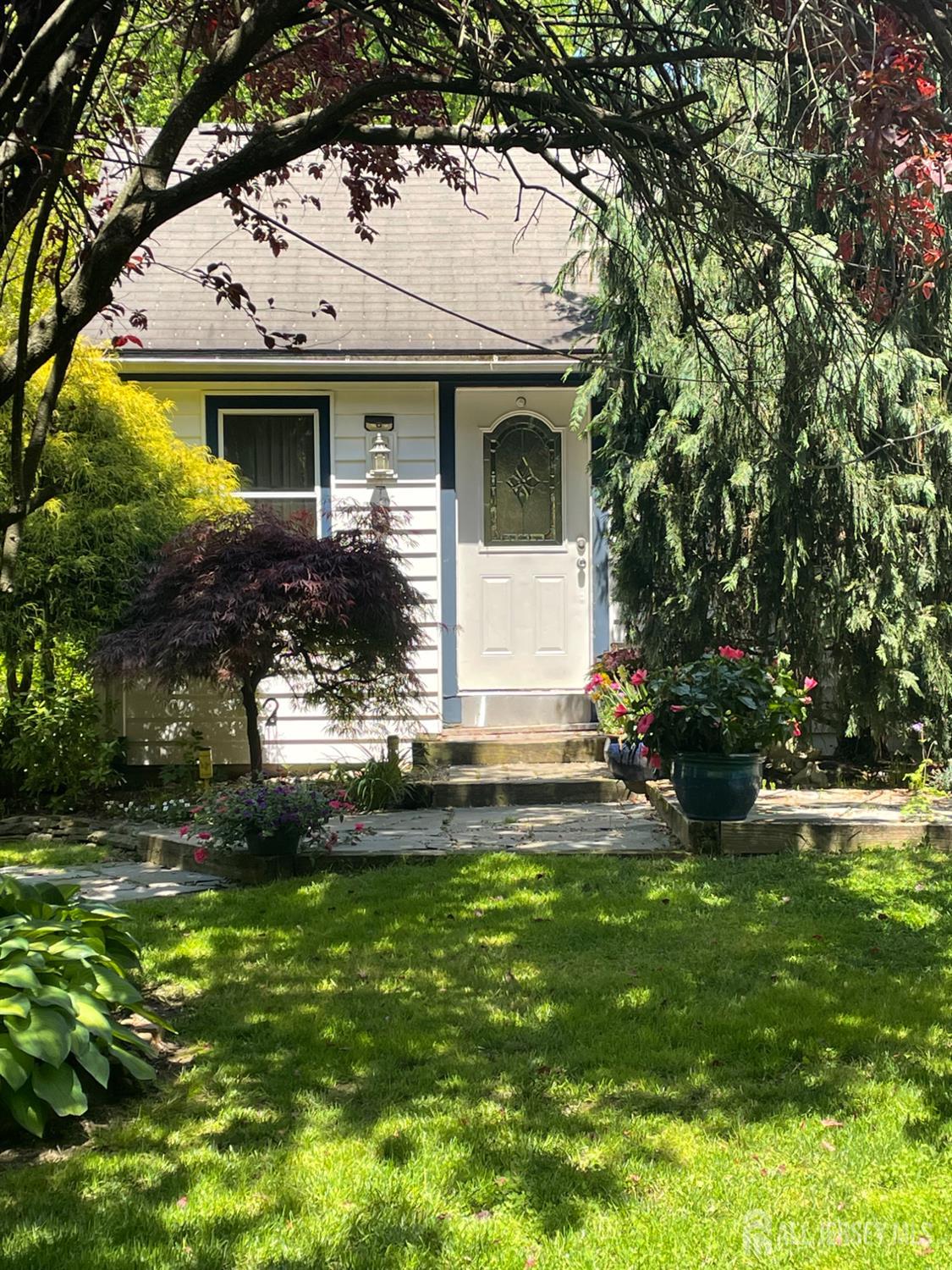 181 Disbrow Hill Road Monroe Township, NJ 08831 - Photo 16 of 21 a view of a white house with a big yard and potted plants