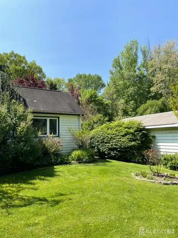 a view of a garden with sitting area