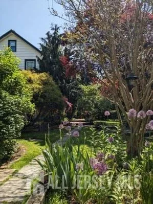 a backyard of a house with lots of green space and garden