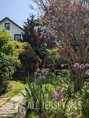 181 Disbrow Hill Road Monroe Township, NJ 08831 - Photo 9 of 21 a backyard of a house with lots of green space and garden