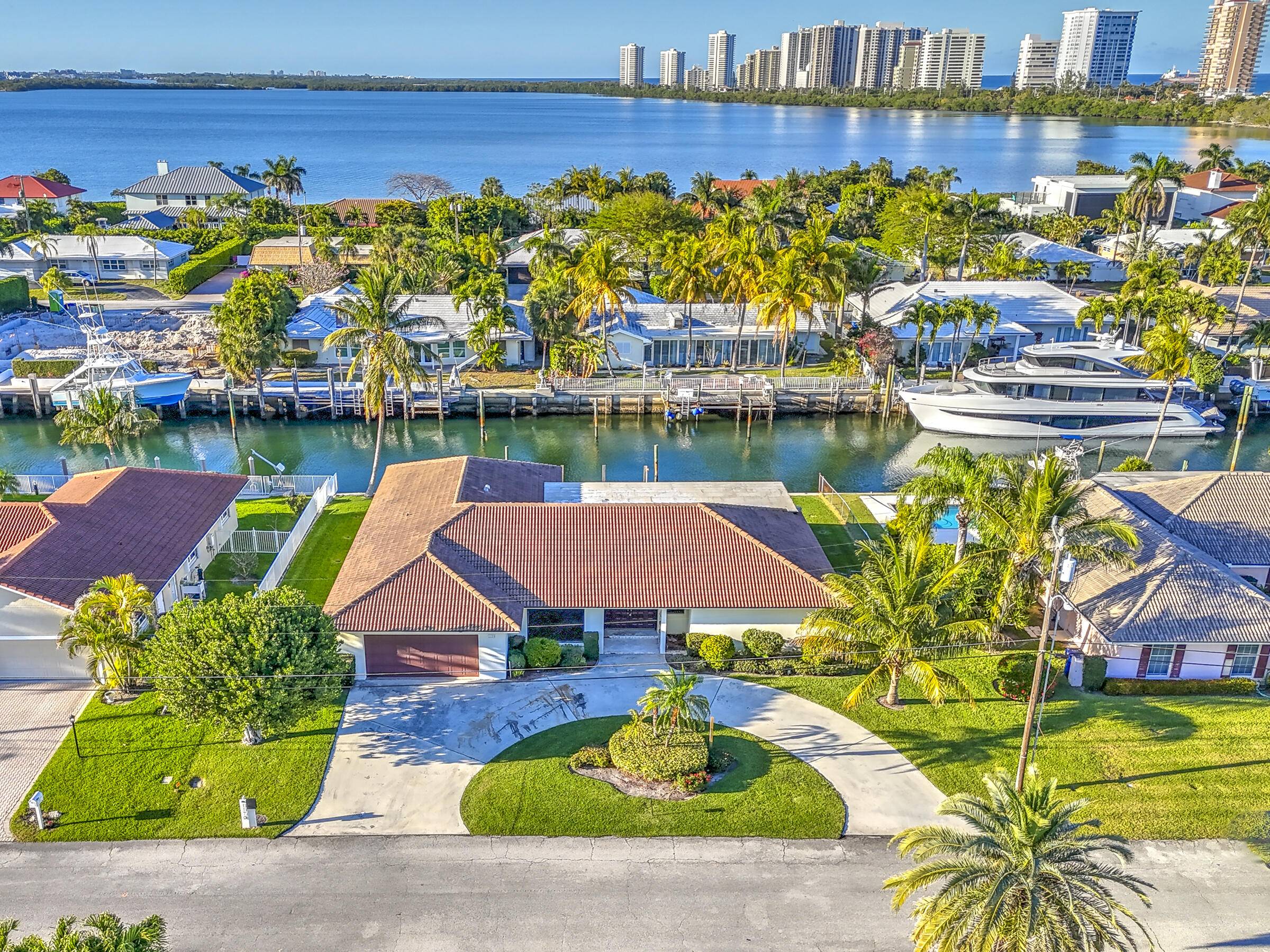 1170 Fairview Lane Singer Island, FL 33404 - Photo 1 of 10 a view of a swimming pool with a lawn chairs under an umbrella