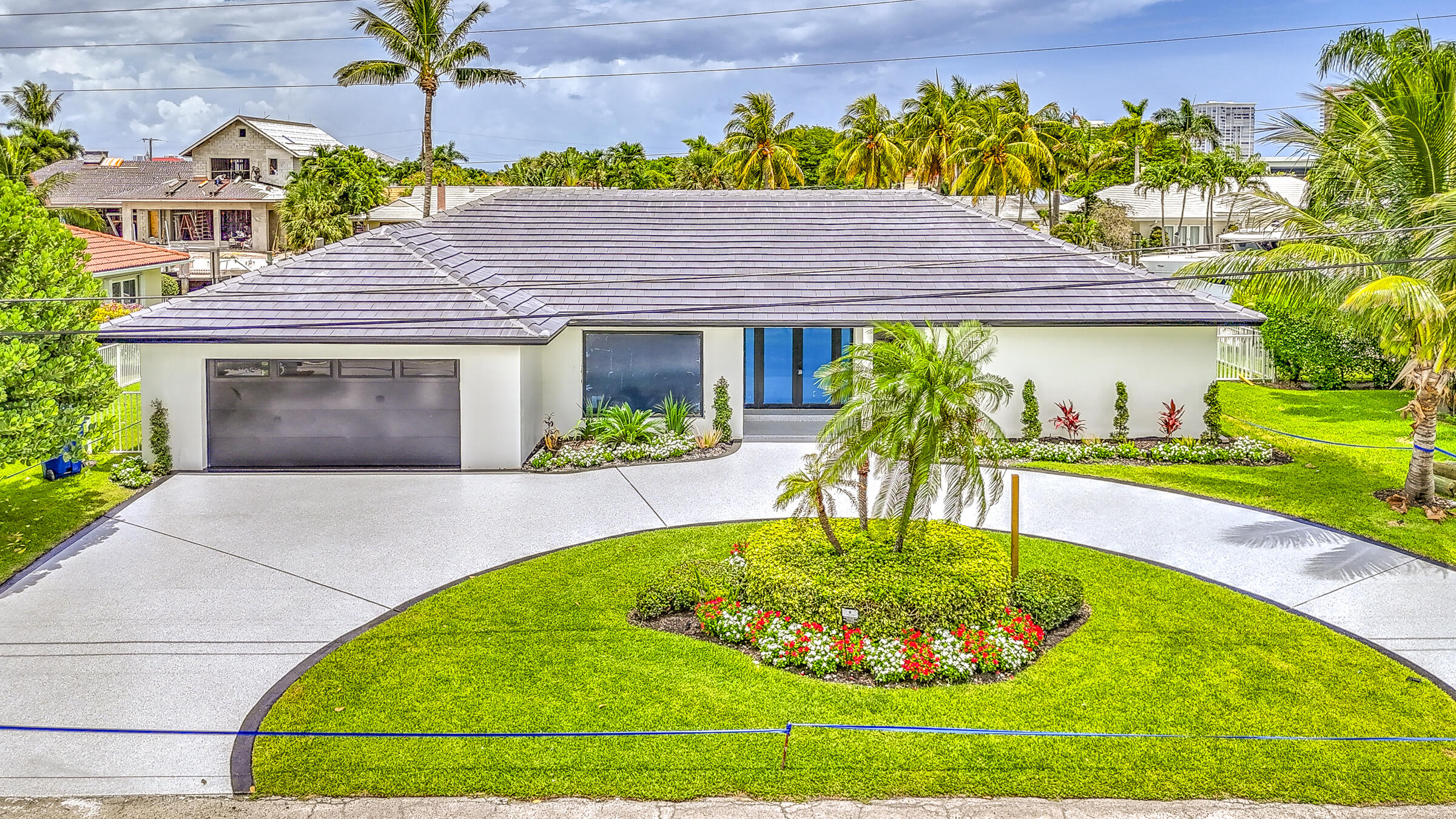 1170 Fairview Lane Singer Island, FL 33404 - Photo 4 of 18 a front view of a house with a yard and garage