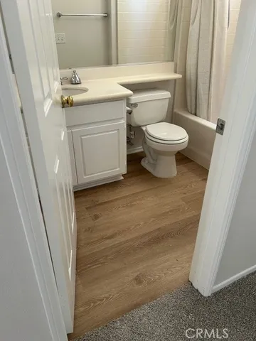 a bathroom with a sink a toilet a mirror and vanity