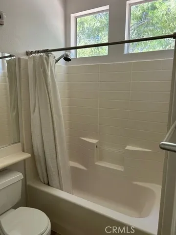 a bathroom with a shower and a toilet