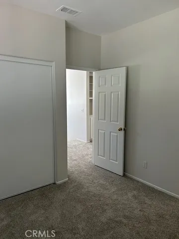 an empty room with closet area