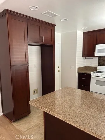a kitchen with a refrigerator and a sink