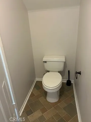 a bathroom with a white toilet