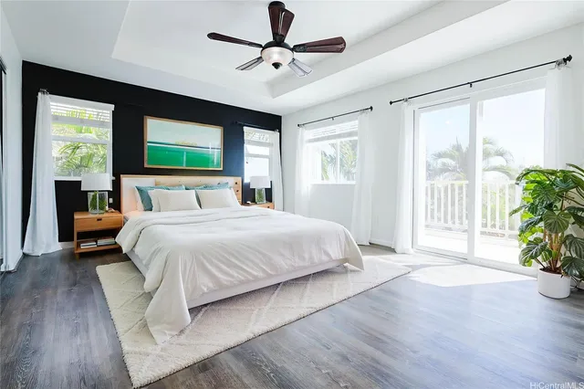 a spacious bedroom with a balcony a bed and a flat screen tv