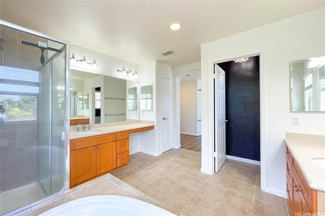 a large bathroom with a large mirror vanity and shower