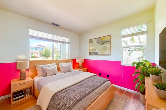 a bedroom with a bed and wooden floor