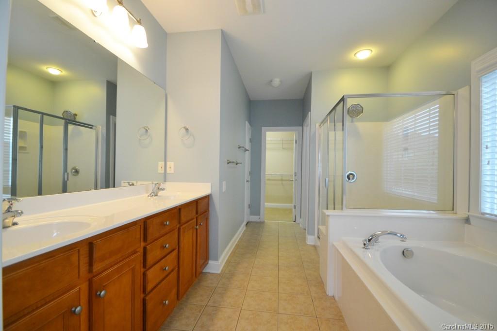 9433 Ridgeforest Drive Charlotte, NC 28277 - Photo 13 of 18 a spacious bathroom with a bathtub shower sink double and mirror