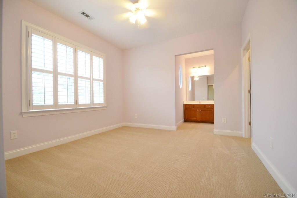 9433 Ridgeforest Drive Charlotte, NC 28277 - Photo 16 of 18 an empty room with windows and cabinet