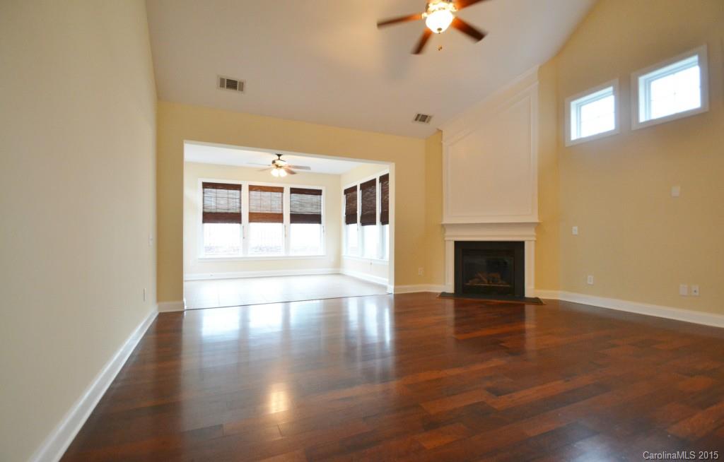 9433 Ridgeforest Drive Charlotte, NC 28277 - Photo 8 of 18 a view of empty room with a fireplace and wooden floor