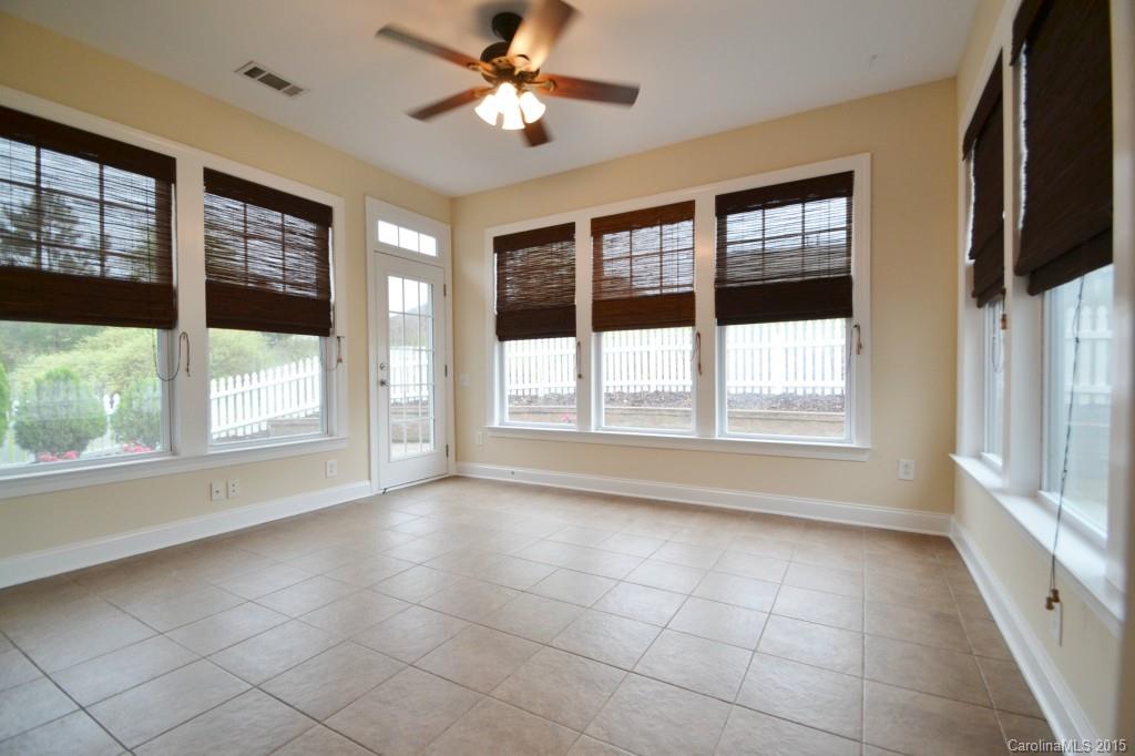 9433 Ridgeforest Drive Charlotte, NC 28277 - Photo 9 of 18 a view of an empty room with a window and a ceiling fan