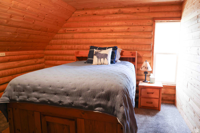 15253 Mill Road, Unit 62 Huntsville, UT 84317 - Photo 22 of 48 Wood-paneled room featuring a sloped ceiling and a single window
