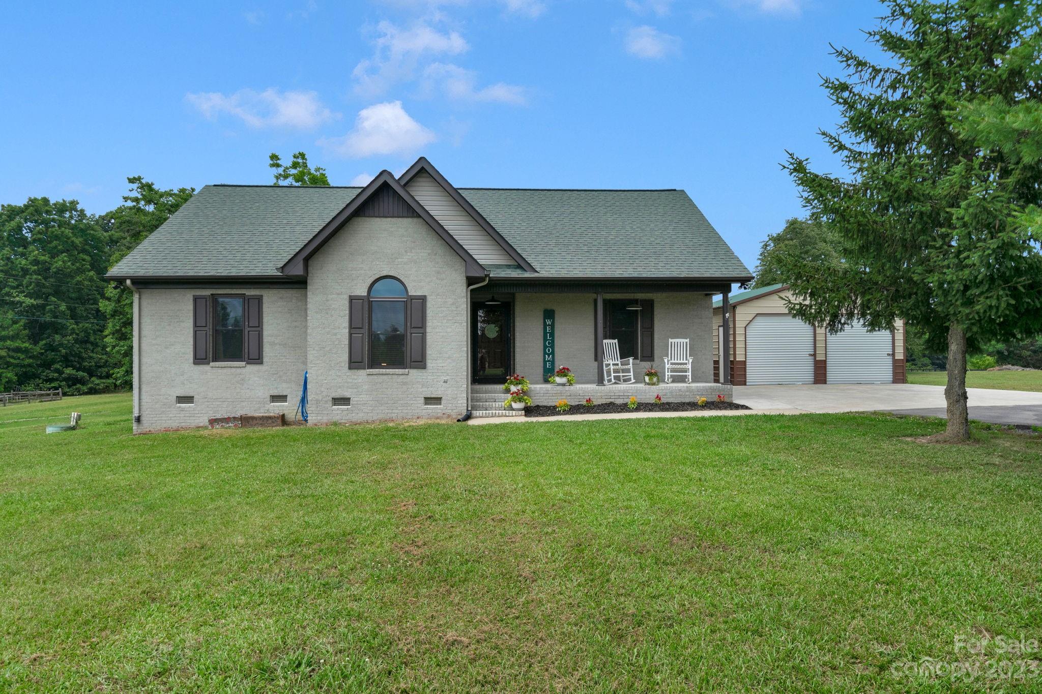 3016 Old Montgomery Place Road Monroe, NC 28112 - Photo 1 of 40 a front view of a house with yard and green space