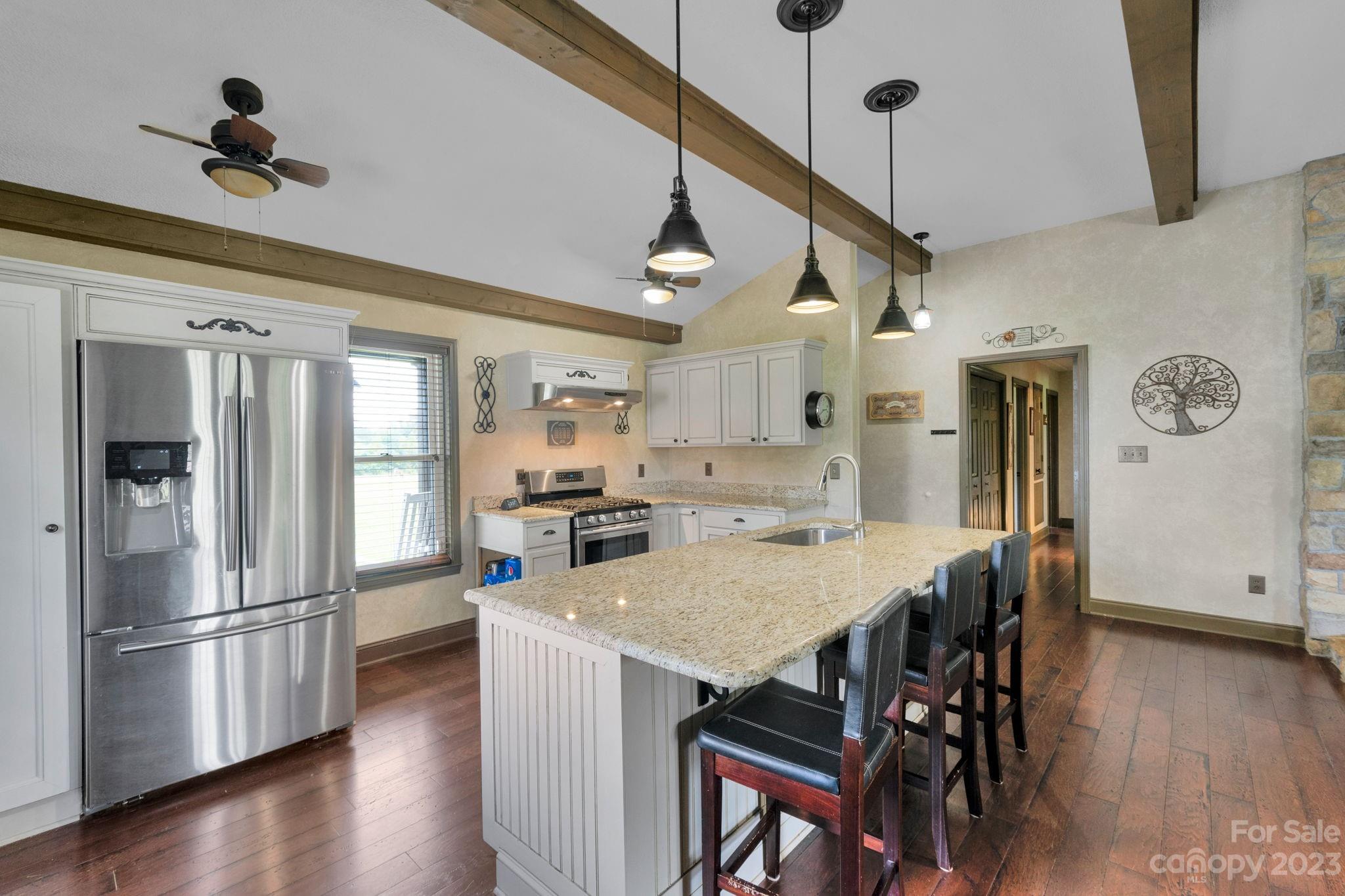 3016 Old Montgomery Place Road Monroe, NC 28112 - Photo 11 of 40 a kitchen with stainless steel appliances granite countertop a refrigerator a sink dishwasher a stove and a refrigerator with wooden floor