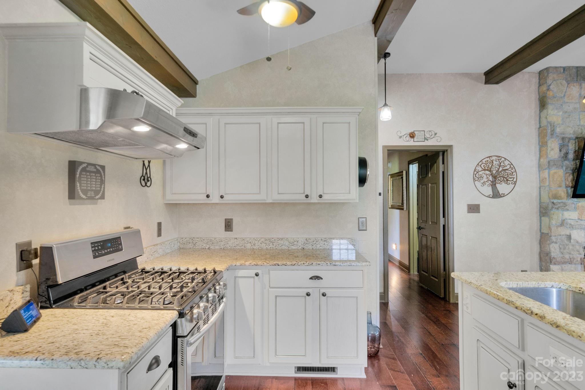 3016 Old Montgomery Place Road Monroe, NC 28112 - Photo 12 of 40 a kitchen with granite countertop a sink a stove top oven and cabinets