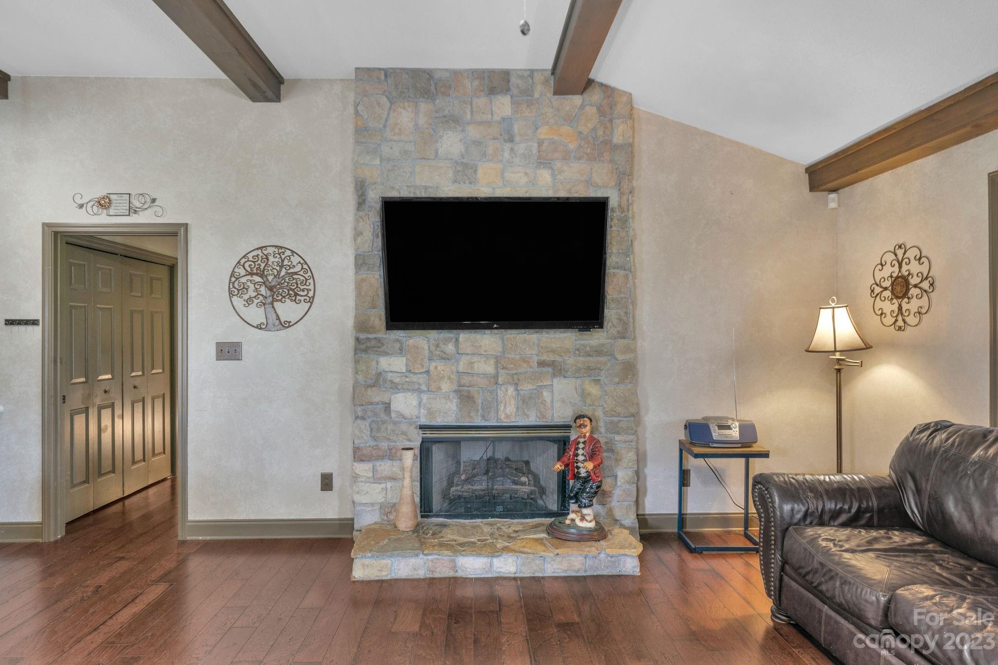 3016 Old Montgomery Place Road Monroe, NC 28112 - Photo 15 of 40 a living room with furniture a fireplace and a flat screen tv