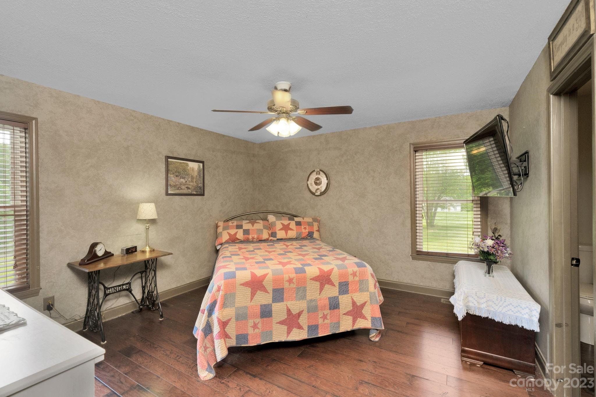 3016 Old Montgomery Place Road Monroe, NC 28112 - Photo 21 of 40 a bedroom with a bed and a chandelier