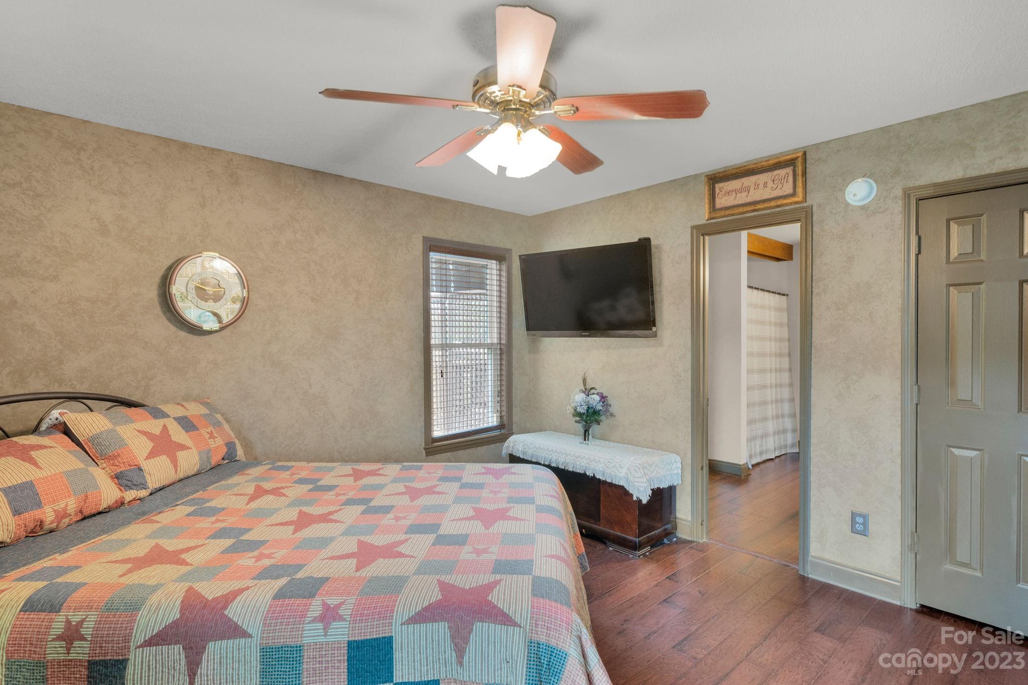 3016 Old Montgomery Place Road Monroe, NC 28112 - Photo 22 of 40 a bedroom with a bed and a flat tv screen on dresser