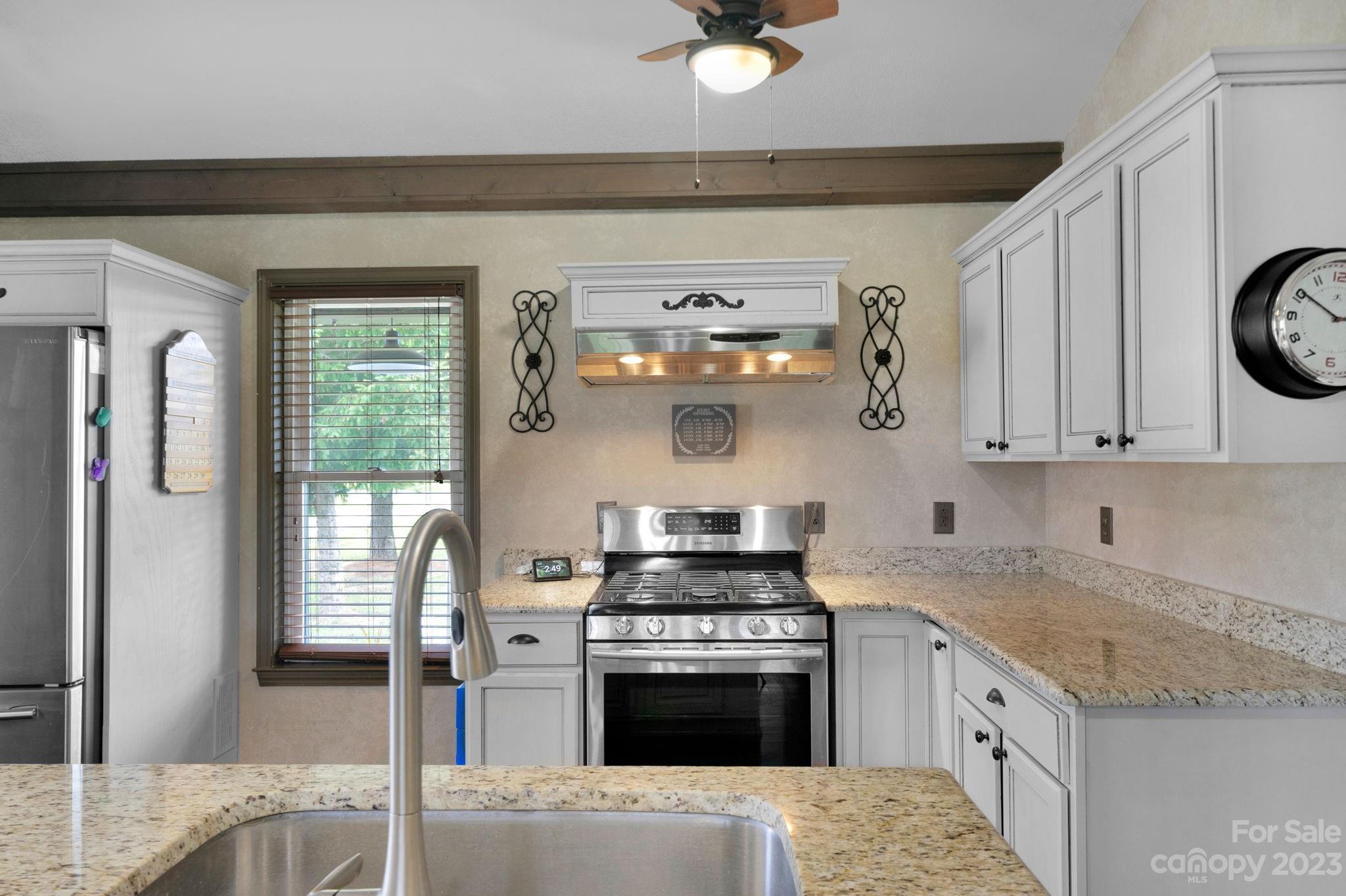 3016 Old Montgomery Place Road Monroe, NC 28112 - Photo 27 of 40 a kitchen with stainless steel appliances granite countertop a stove a sink and a refrigerator