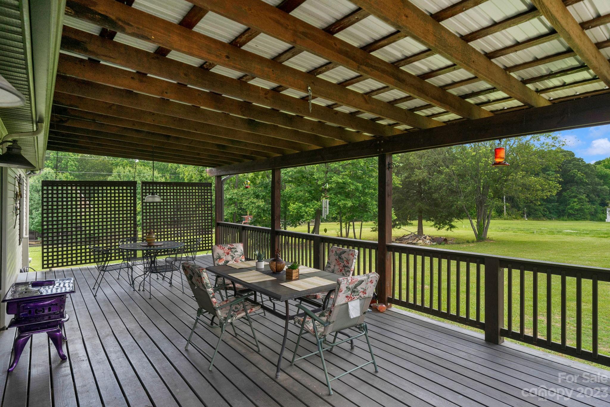 3016 Old Montgomery Place Road Monroe, NC 28112 - Photo 28 of 40 a balcony with wooden floor outdoor seating and nature