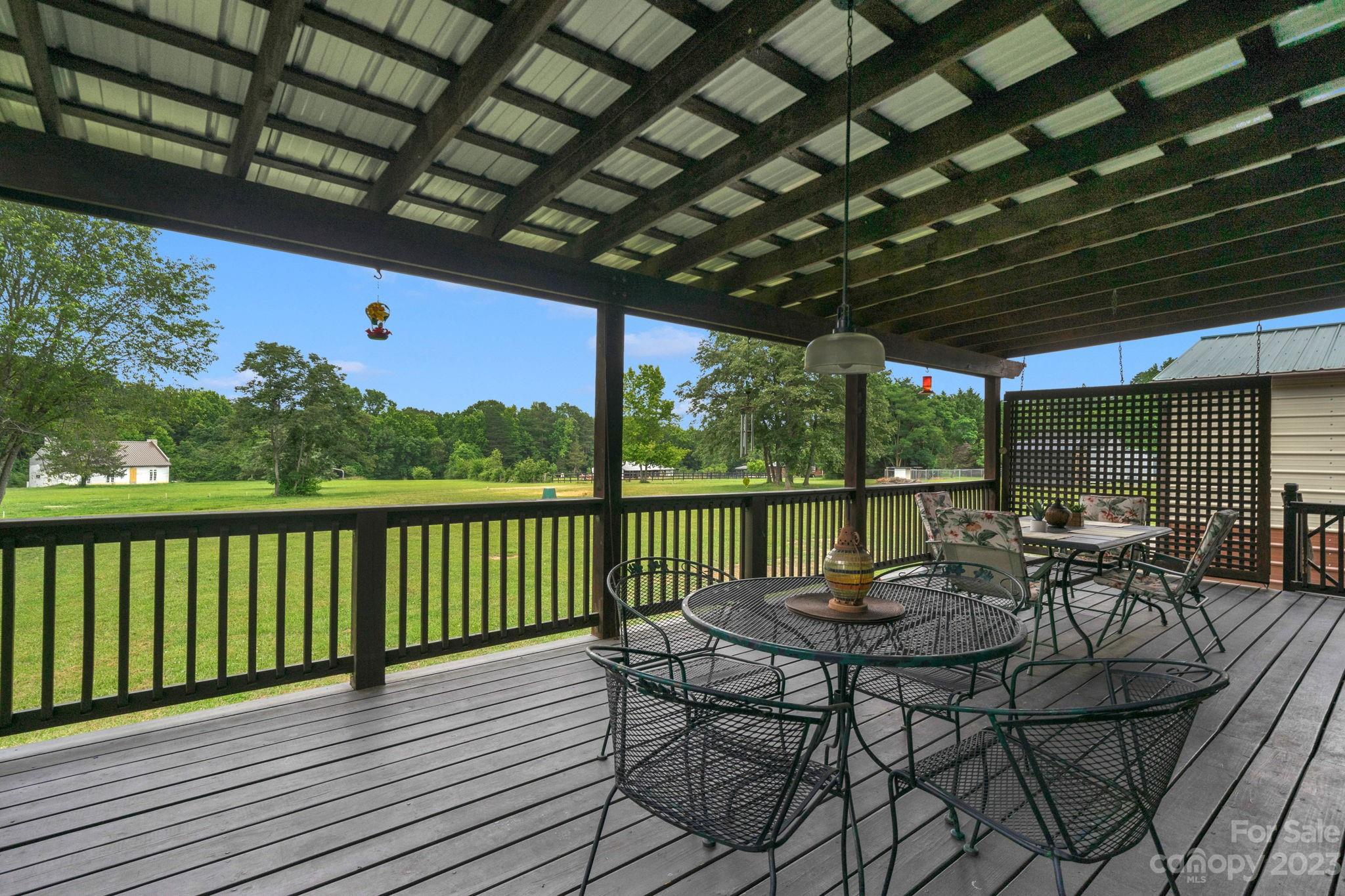 3016 Old Montgomery Place Road Monroe, NC 28112 - Photo 30 of 40 a view of a chairs and table in patio with wooden fence