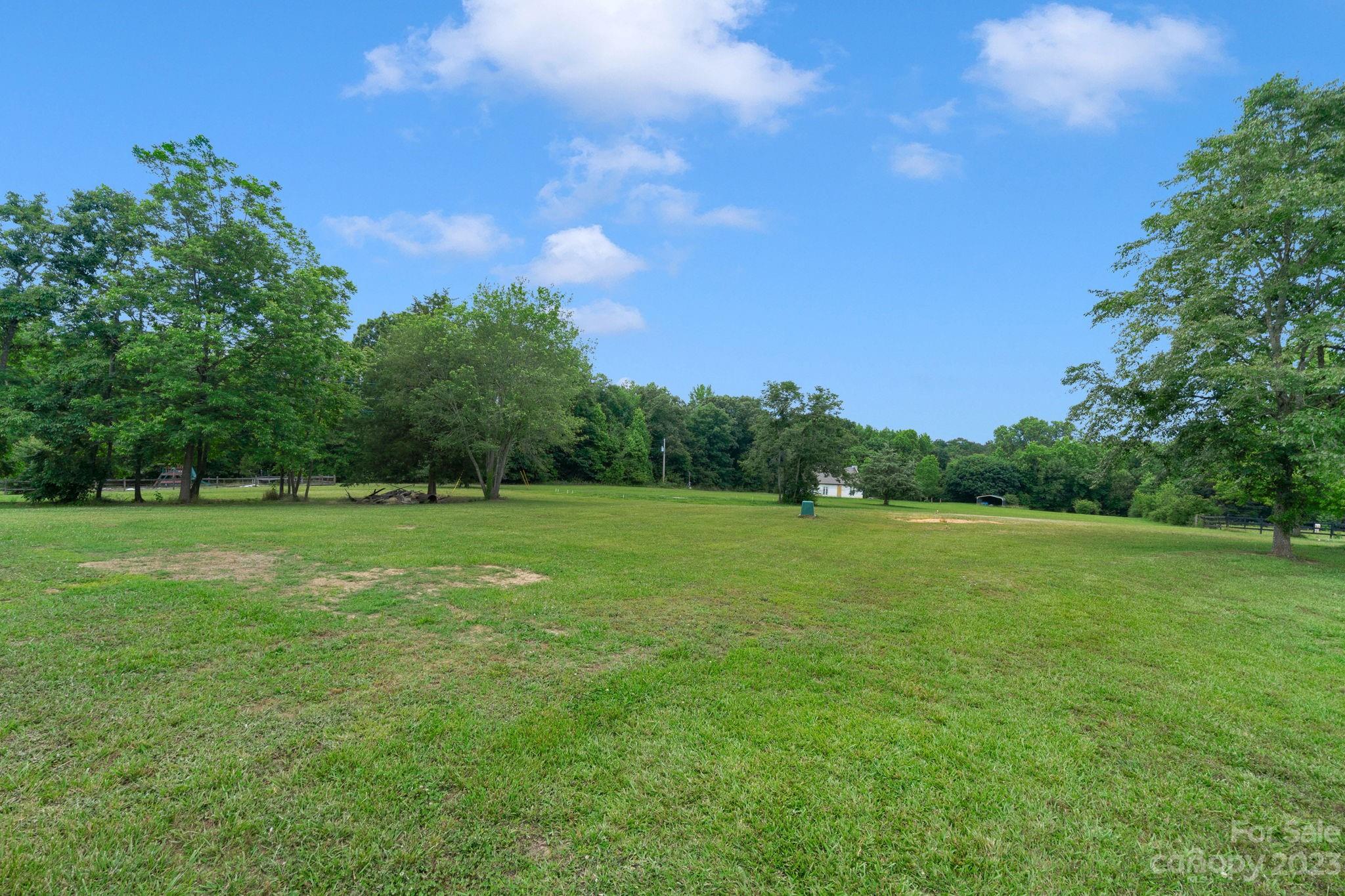 3016 Old Montgomery Place Road Monroe, NC 28112 - Photo 31 of 40 a view of field with trees in the background