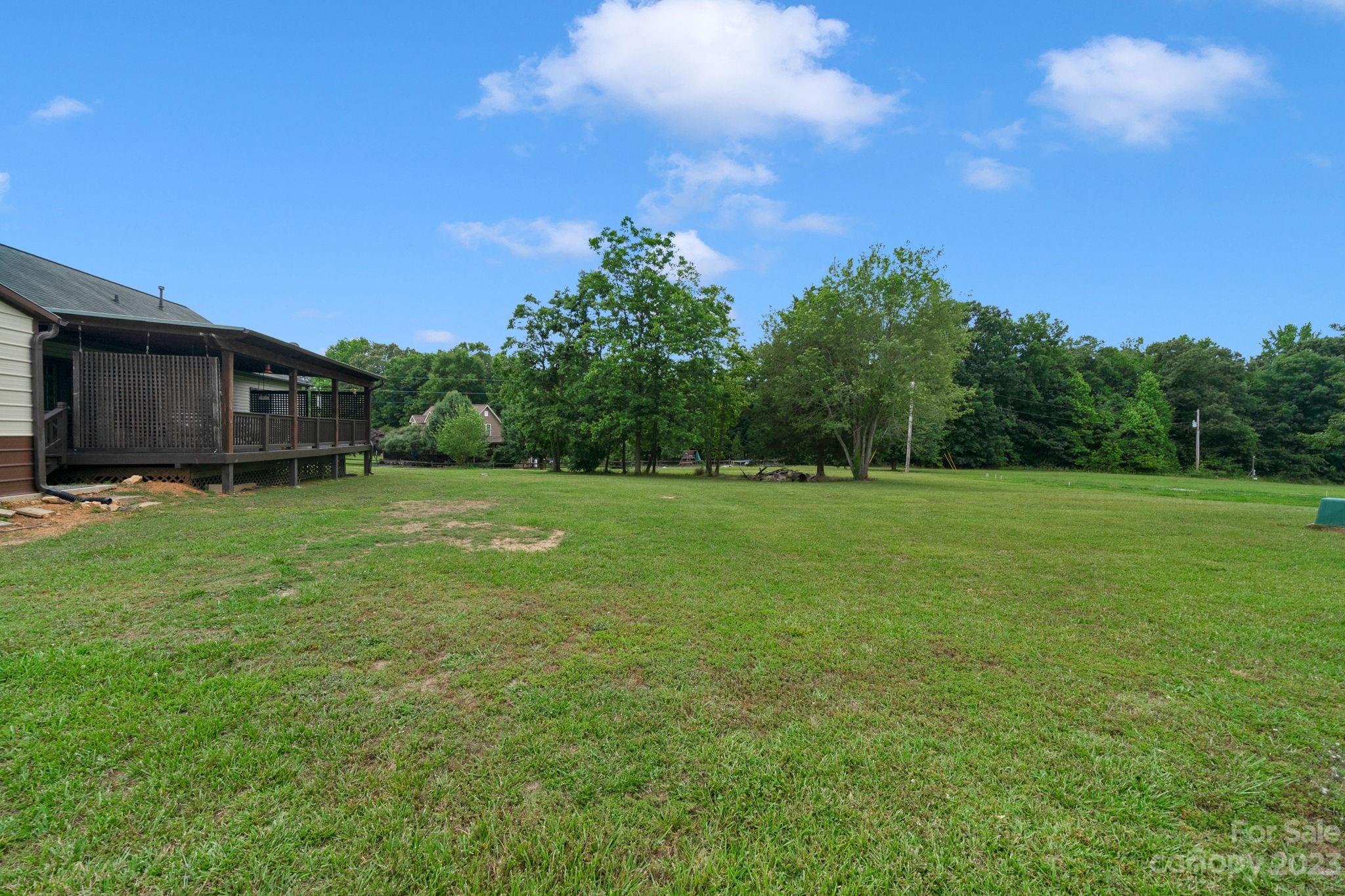 3016 Old Montgomery Place Road Monroe, NC 28112 - Photo 32 of 40 a view of a green field with wooden fence