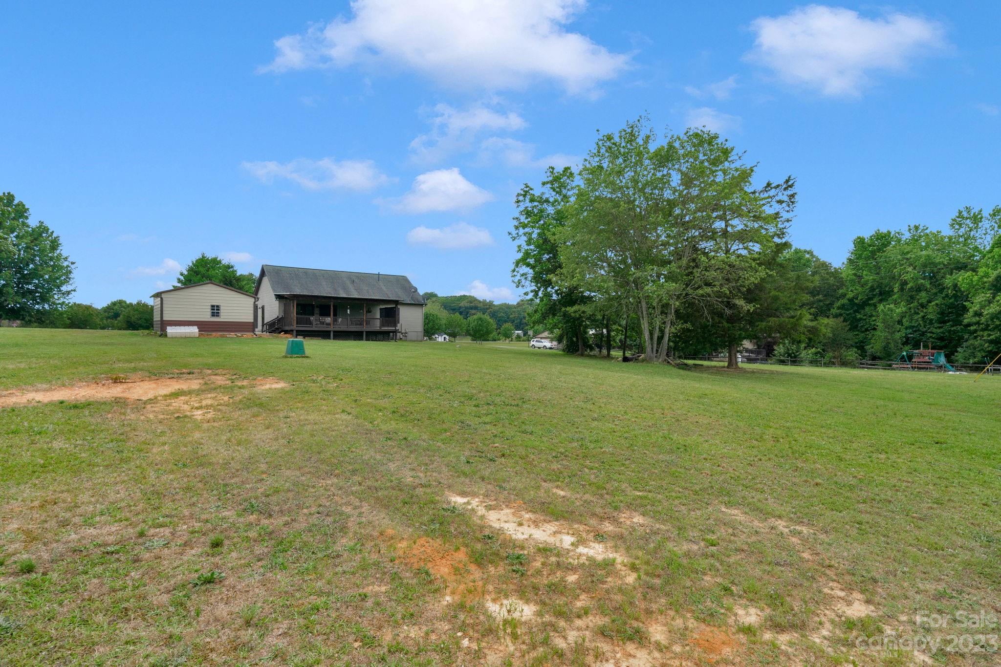 3016 Old Montgomery Place Road Monroe, NC 28112 - Photo 33 of 40 a view of a field with large trees