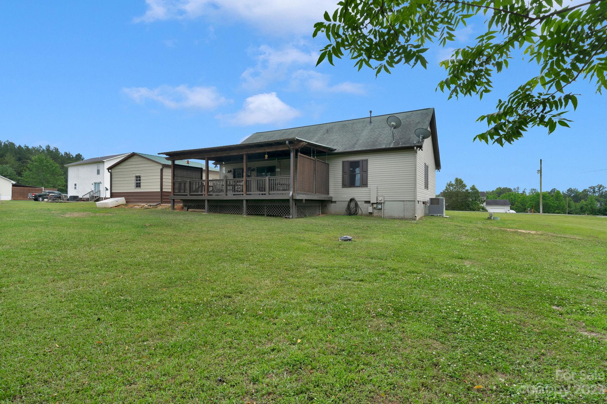 3016 Old Montgomery Place Road Monroe, NC 28112 - Photo 36 of 40 a view of a house with a big yard and large trees