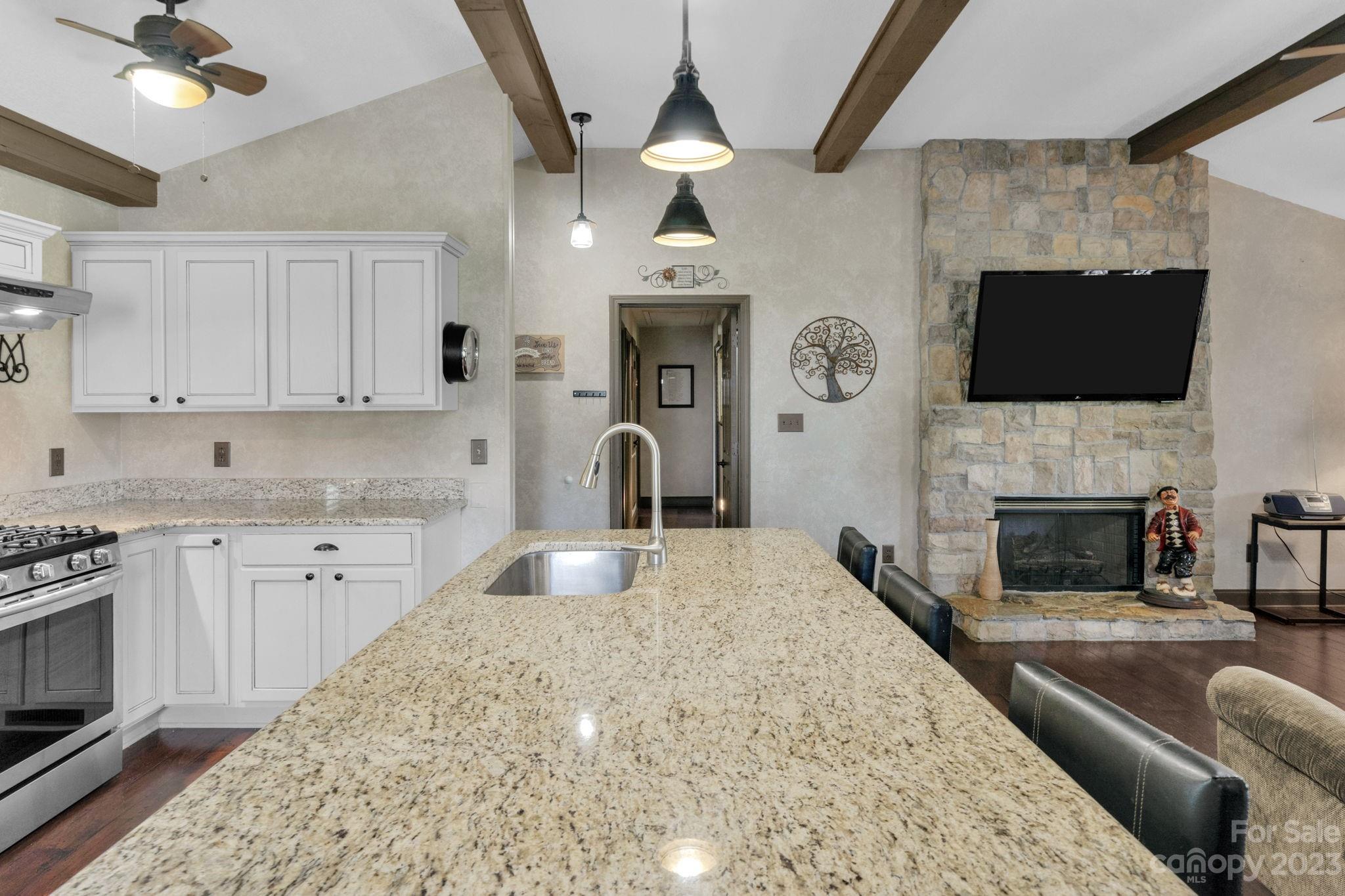 3016 Old Montgomery Place Road Monroe, NC 28112 - Photo 10 of 40 a spacious kitchen with a stove a sink and a fireplace