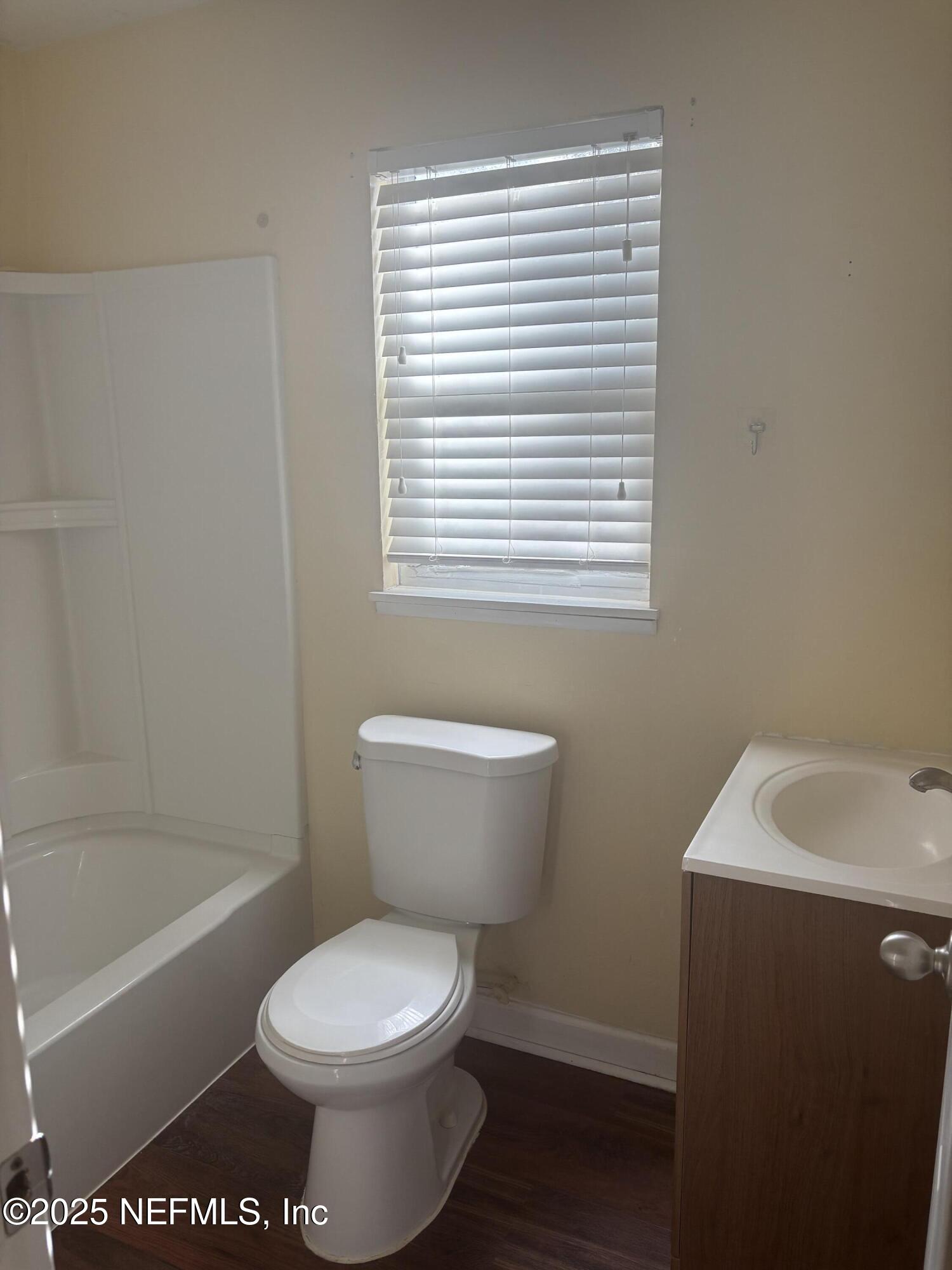428 Neptune Road Orange Park, FL 32073 - Photo 11 of 14 a white toilet sitting next to a bath tub