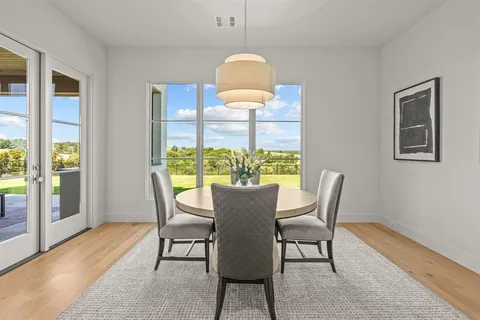 a view of a dining room with furniture window and wooden floor
