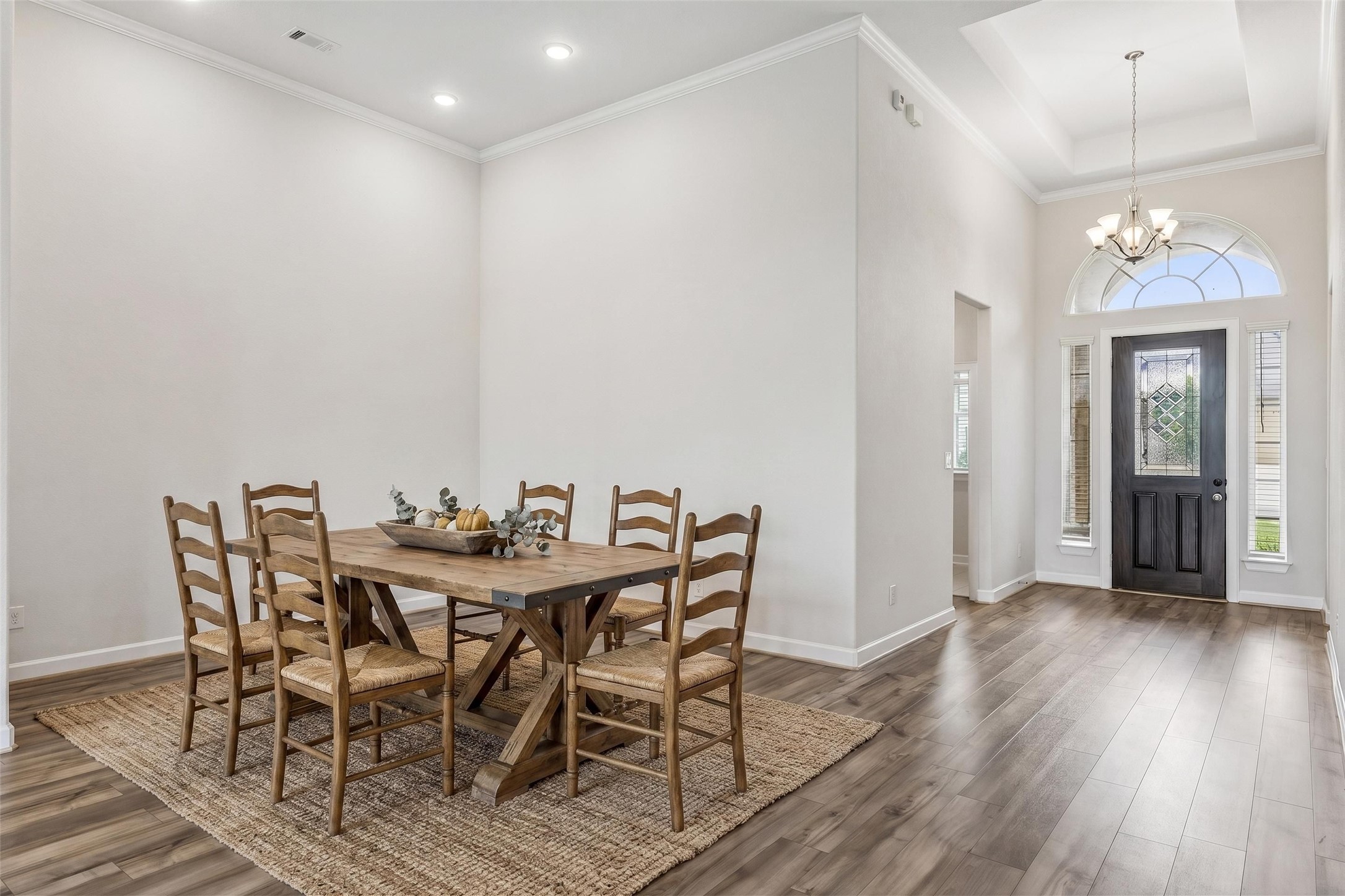 298 Wild Pecan Loop Buda, TX 78610 - Photo 4 of 40 a view of a dining room with furniture and wooden floor