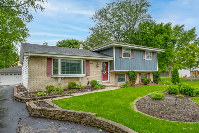 a front view of a house with a yard table and chairs