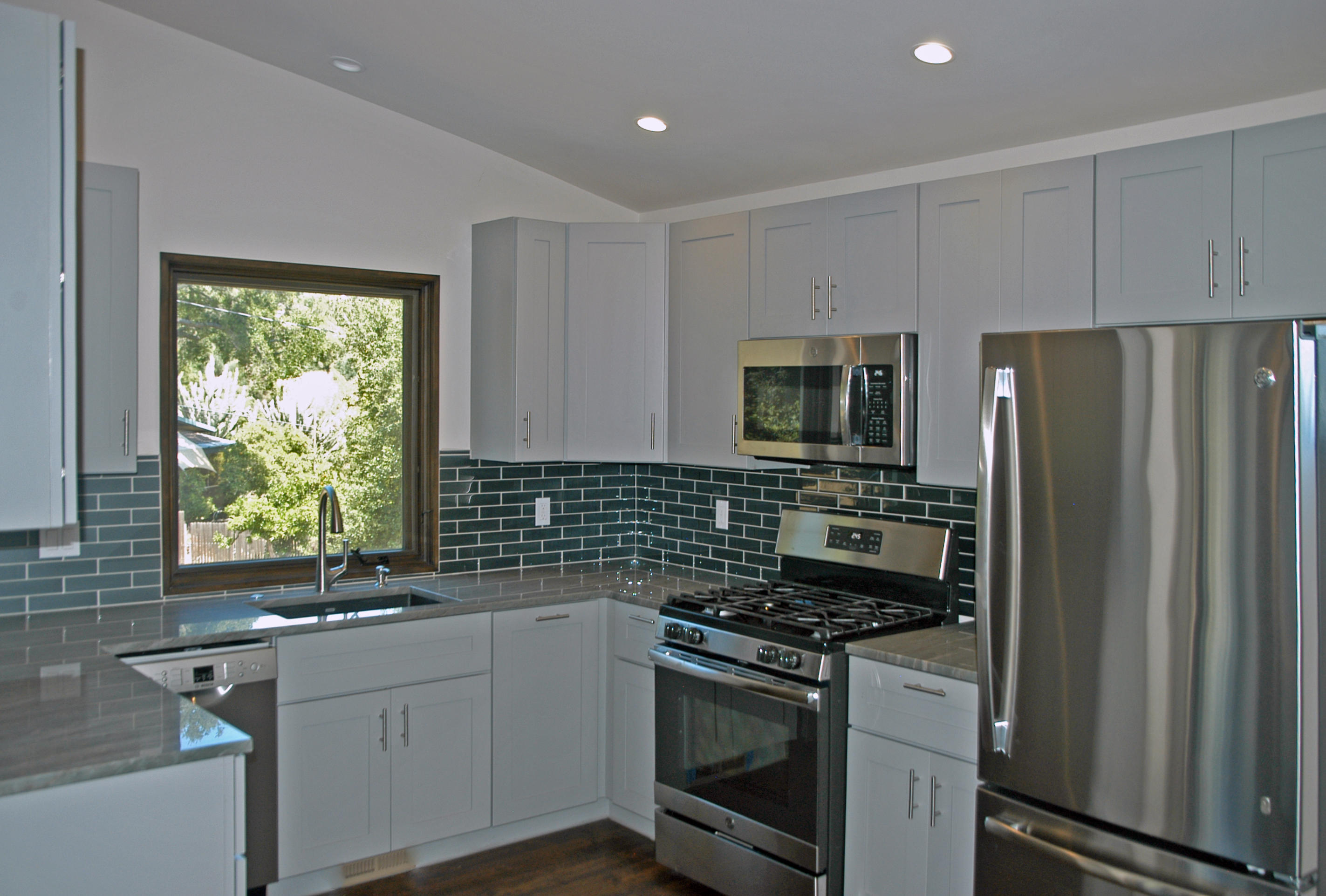 1454 Tunnel Road, Unit GUEST APARTMENT Santa Barbara, CA 93105 - Photo 5 of 10 a kitchen with stainless steel appliances granite countertop a stove a sink and a refrigerator