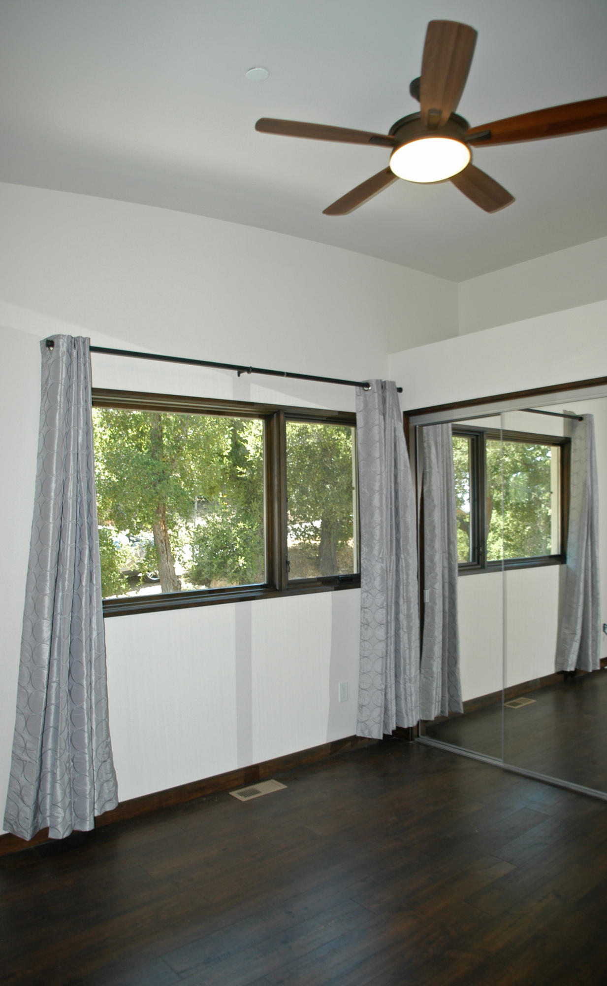 1454 Tunnel Road, Unit GUEST APARTMENT Santa Barbara, CA 93105 - Photo 6 of 10 a view of an empty room with wooden floor and a window