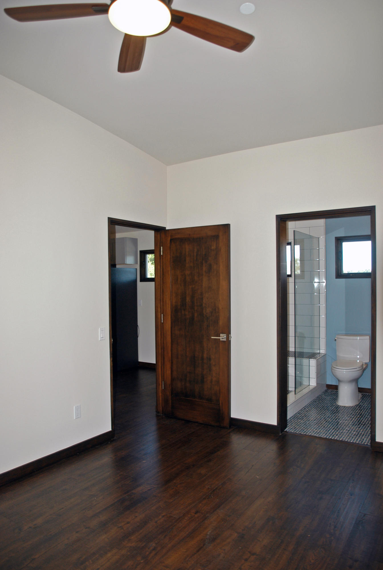 1454 Tunnel Road, Unit GUEST APARTMENT Santa Barbara, CA 93105 - Photo 7 of 10 a view of an empty room with wooden floor and a ceiling fan